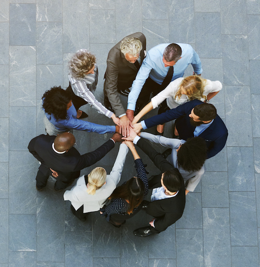 Multiracial business people having teambuilding with hands stacked